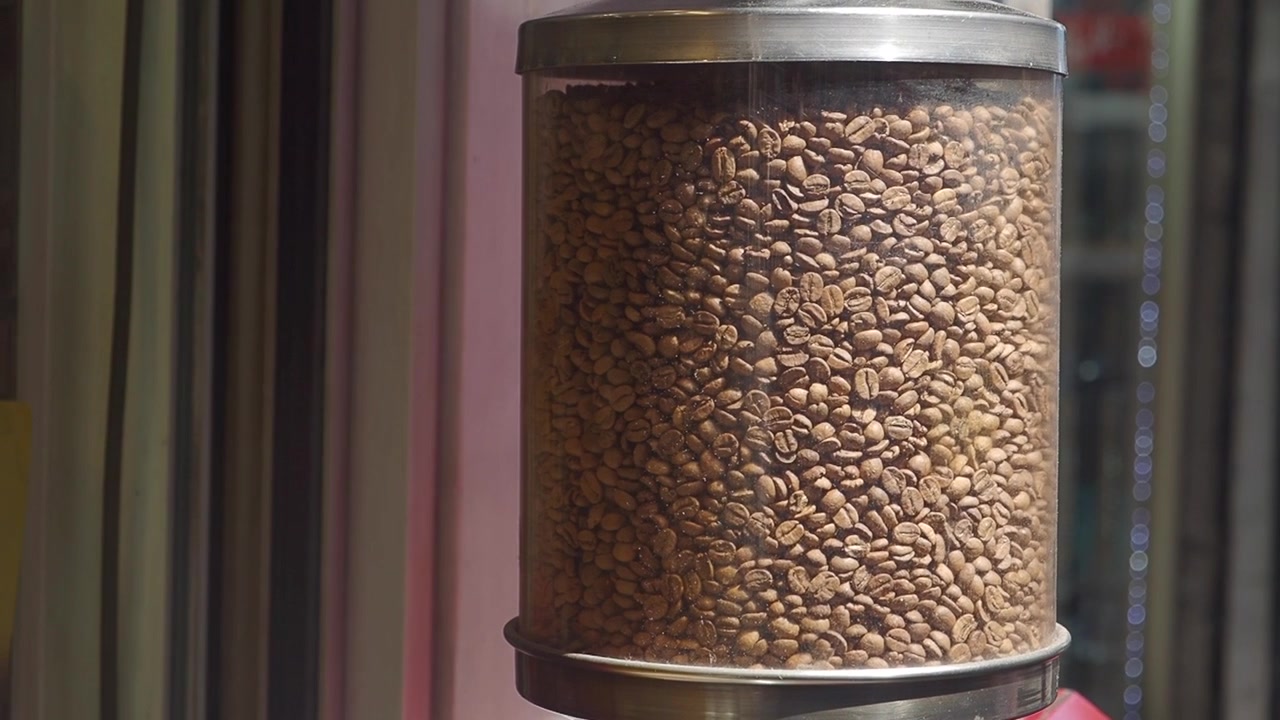 Roasted Coffee Beans in a Transparent Glass Dispenser