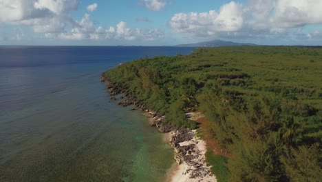 tilt up shot of a drone revealing a tropical beach at tinian, northern mariana islands