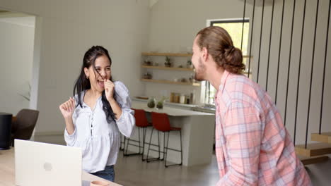 a biracial couple enjoys a playful moment at home