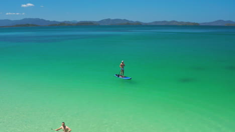 tropical island paradise: stand-up paddleboarding in crystal clear waters