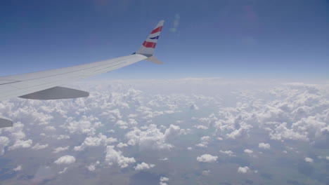 plane over clouds wing view from the window cumulonimbus