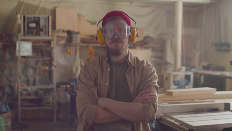 portrait of woodworker in safety glasses and earmuffs