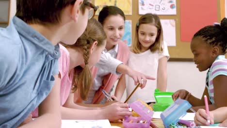 young pretty teacher having lesson to children