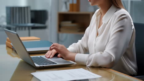 Woman working on a laptop in an office setting