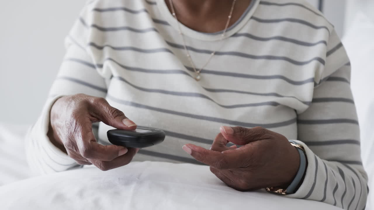 Senior african american woman checking blood pressure, slow motion