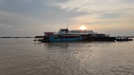 a panoramic boat shot of tonle sap lake, cambodia, reveals a floating village filled with houses on the water