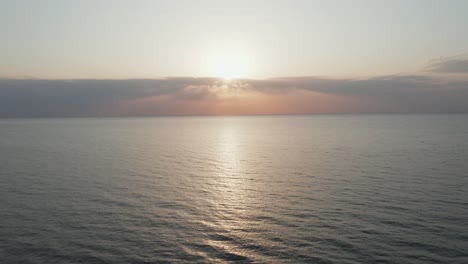 AERIAL:-Calm-and-Romantic-Baltic-Sea-on-a-Lovely-Spring-evening-with-Sun-Setting-Down