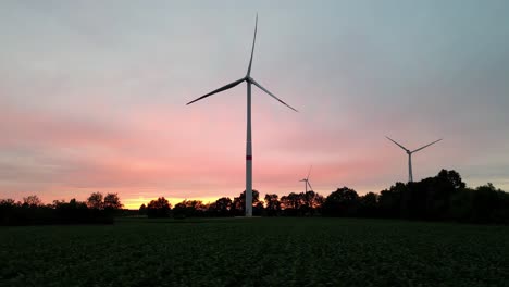 static wind turbines during majestic sunset, aerial view