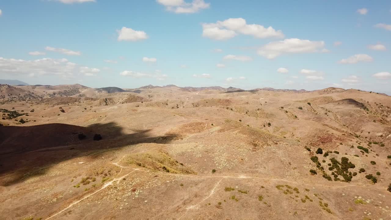 Desert landscape hills after Hidden Hills Town in California. Endless mountains landscape in nature reserve. Wide shot drone.