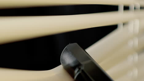 Extreme-closeup-of-barrel-of-gun-parting-blinds-at-night