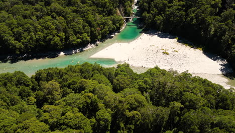 Iconic-mountain-river-with-sandy-beach-of-New-Zealand,-aerial-drone-view