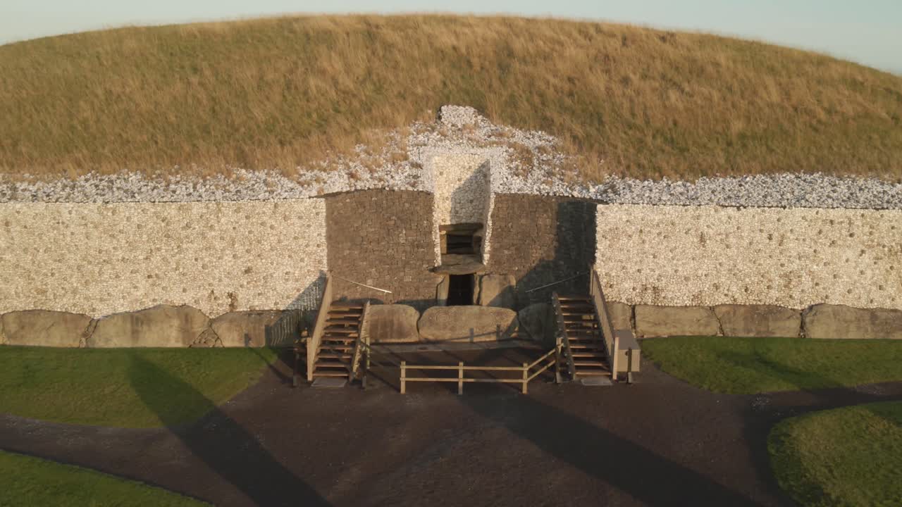 Ancient Newgrange tomb illuminated by sunrise in County Meath, Ireland