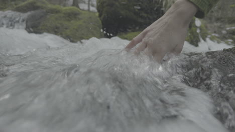 hand in a mountain stream