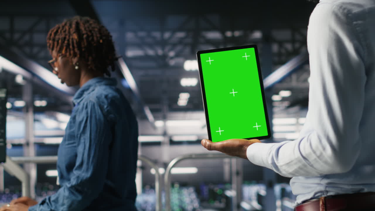 Close up of server hub admin using isolated screen tablet next to colleague