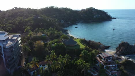 drone: orbit shot of sayulita beach and beach of the death in mexico