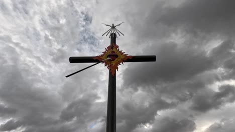 the cross of the apostolate is a sign of love and encounter with god and the clouds that pass quickly in this sanctuary are incredible