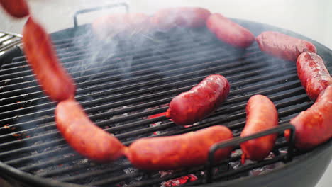 panning shot of rolling mexican grill sausage surrounded by ring of sausage on bbq