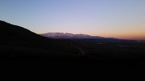 Valley-of-Tears-aerial-view-flyover-at-dusk,-Mount-Hermon-in-background,-Israel