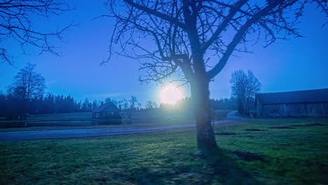 Static-view-of-sun-rising-in-timelapse-over-small-cottages-surrounding-a-pristine-lake-during-early-morning