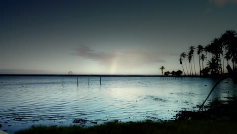 un espectáculo de lapso de tiempo de nubes sobre una escena hawaiana con un arco iris formándose