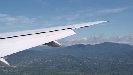 extended flaps on aircraft wing preparing for landing, view from cabin