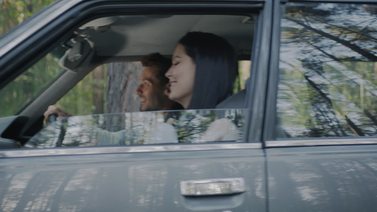 Couple enjoying a road trip through the forest