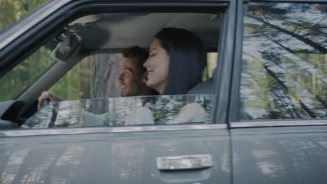 couple enjoying a road trip through the forest