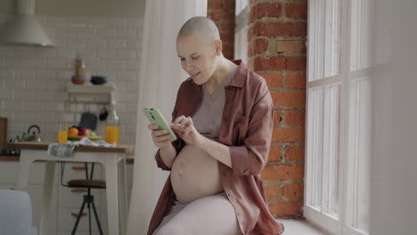 pregnant woman looking at phone