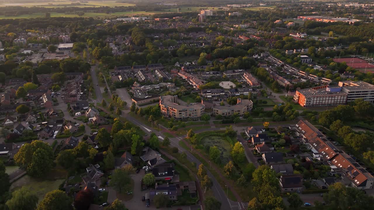 Aerial view of a green suburban residential area with houses and trees