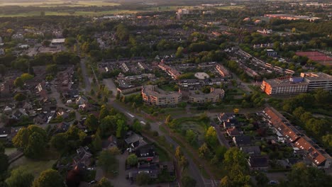 aerial view of a green suburban residential area with houses and trees