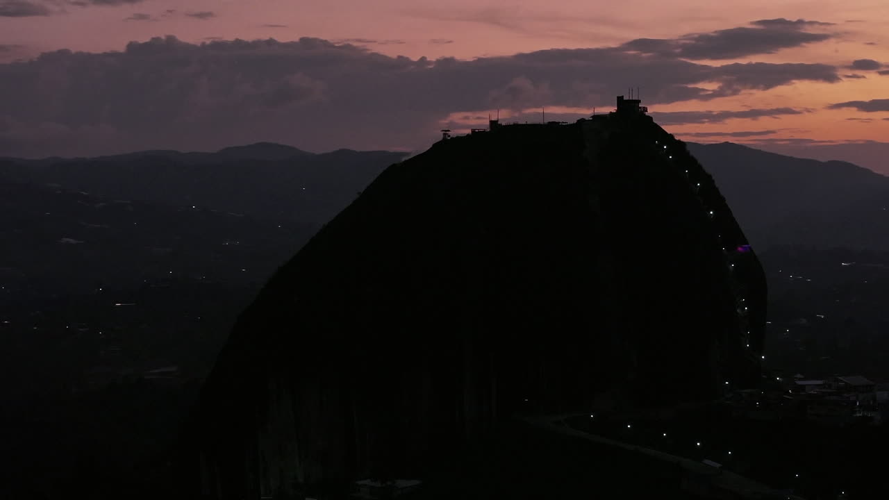 Right Pan Drone Shot El Penon Rock Guatape Colombia Dark Explosive Sky