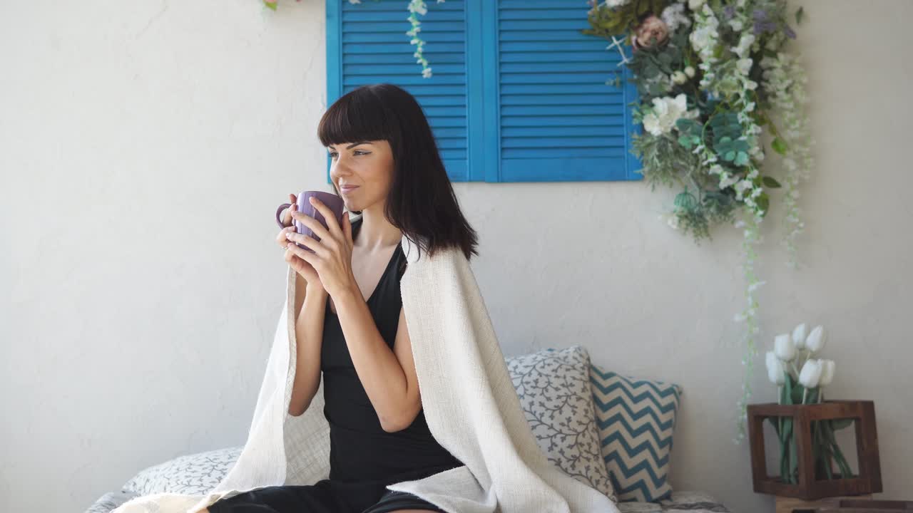 Woman drinking coffee in bed