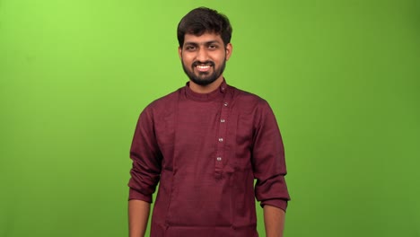 Attractive-Indian-man-showing-negative-emotion-through-head-and-finger-movement-against-a-green-screen