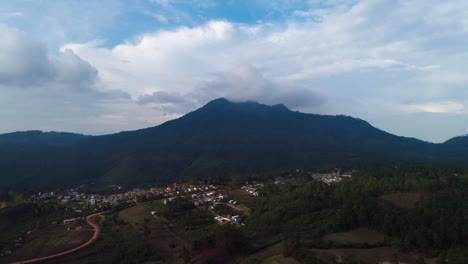 Aerial-shot-of-a-mountain-with-urbanization-nearby-in-Honduras,-Central-America