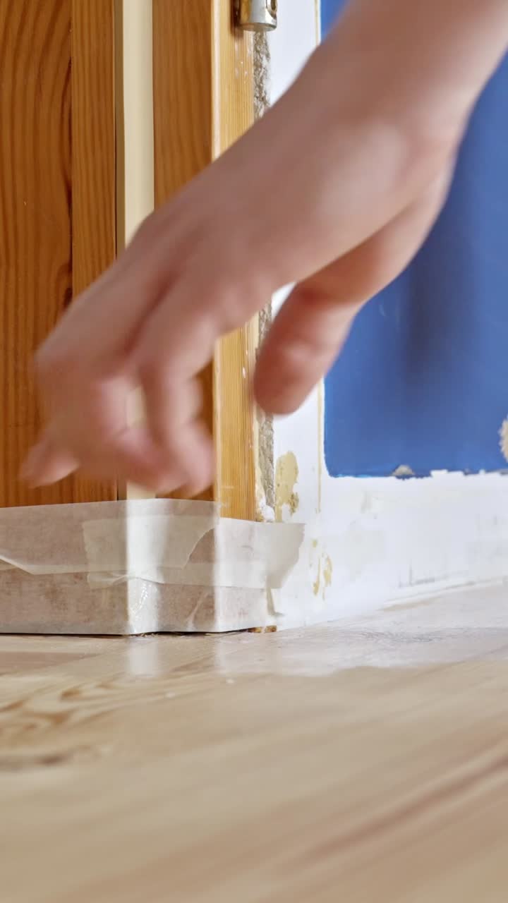 Applying varnish on wood floor in home renovation setting