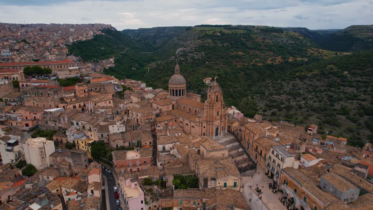Aerial drone above central piazza in Ragusa with historic houses and church towers. Sicily, Italy.