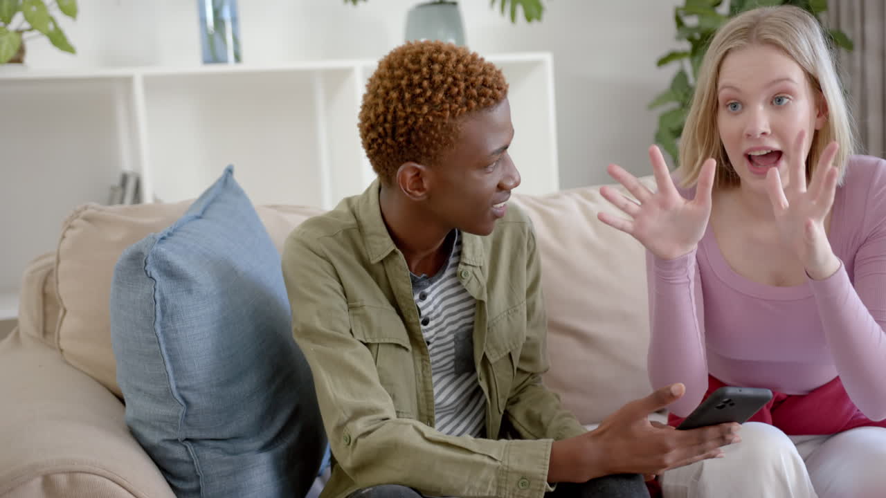 Thoughtful diverse teenage friends at meeting talking at home, slow motion