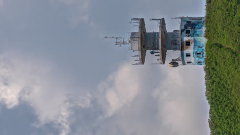 Telecommunications-before-huge-clouds-tower-near-Noumea,-New-Caledonia---vertical-time-lapse