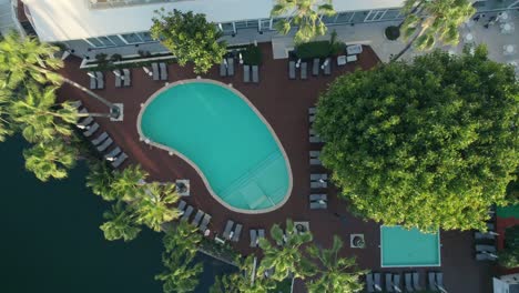 aerial view of a luxury hotel resort with pool and lush landscaping