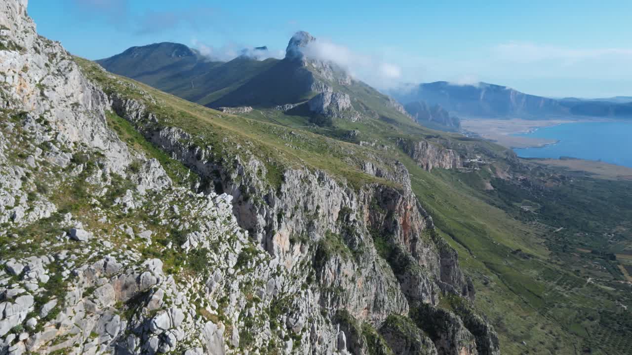 Aerial drone footage of Monte Monaco, San Vito Lo Capo, Sicily: 360° panoramic view of sea and mountains under golden Mediterranean light. Perfect for travel, nature, and adventure projects
