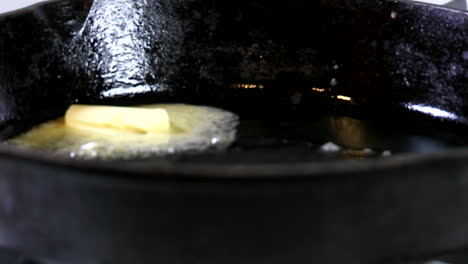 a tab of margarine containing trans fats melts in a hot skillet