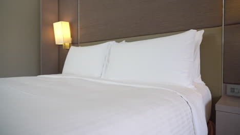 clean hotel bedroom with fresh white besheet and pillows in an empty room