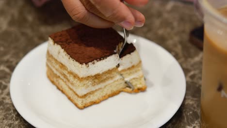 tiramisu slice being eaten