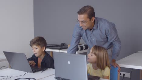 School-teacher-checking-task-of-pupil-girl