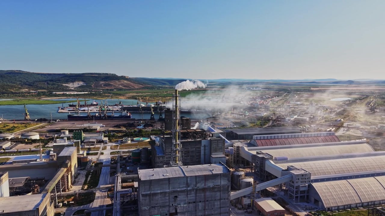 Industriële haven met fabrieken en schepen aan het water overdag