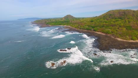 following the waves into shore on a costa rica coast shoreline at piedra point in central america