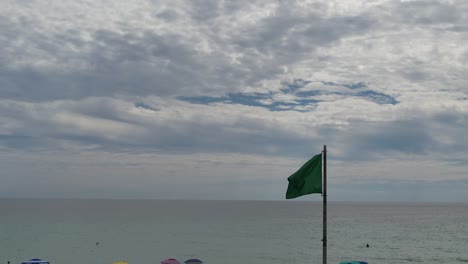 Green-flag-flying-over-the-clear-waters-of-the-Gulf-of-Mexico