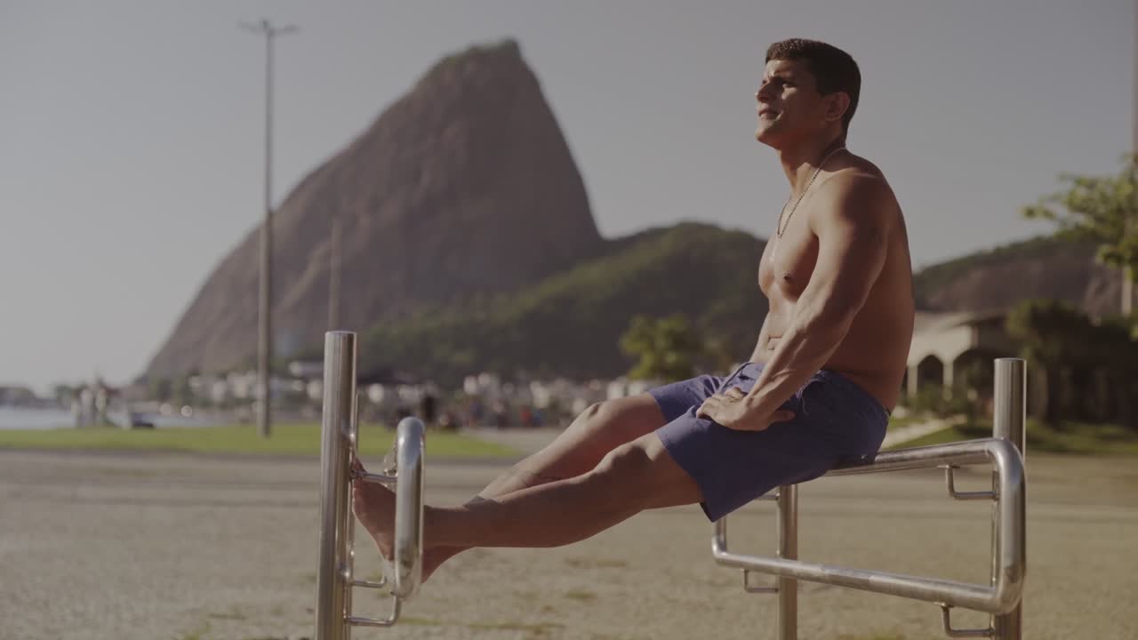 Man performs outdoor exercise with Sugarloaf Mountain in Rio de Janeiro