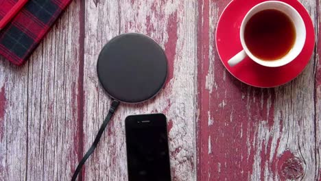 charging phone on wireless pad with tea