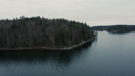 forest and shoreline in swedish archipelago, drone aerial autumn day